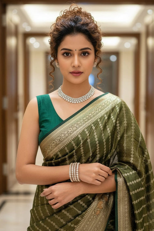 woman in a green striped saree indoors