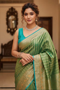 woman wearing green saree indoors