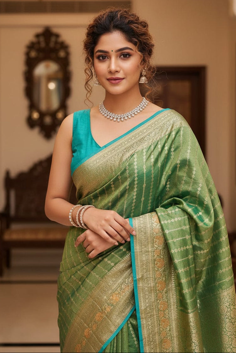 woman wearing green saree indoors