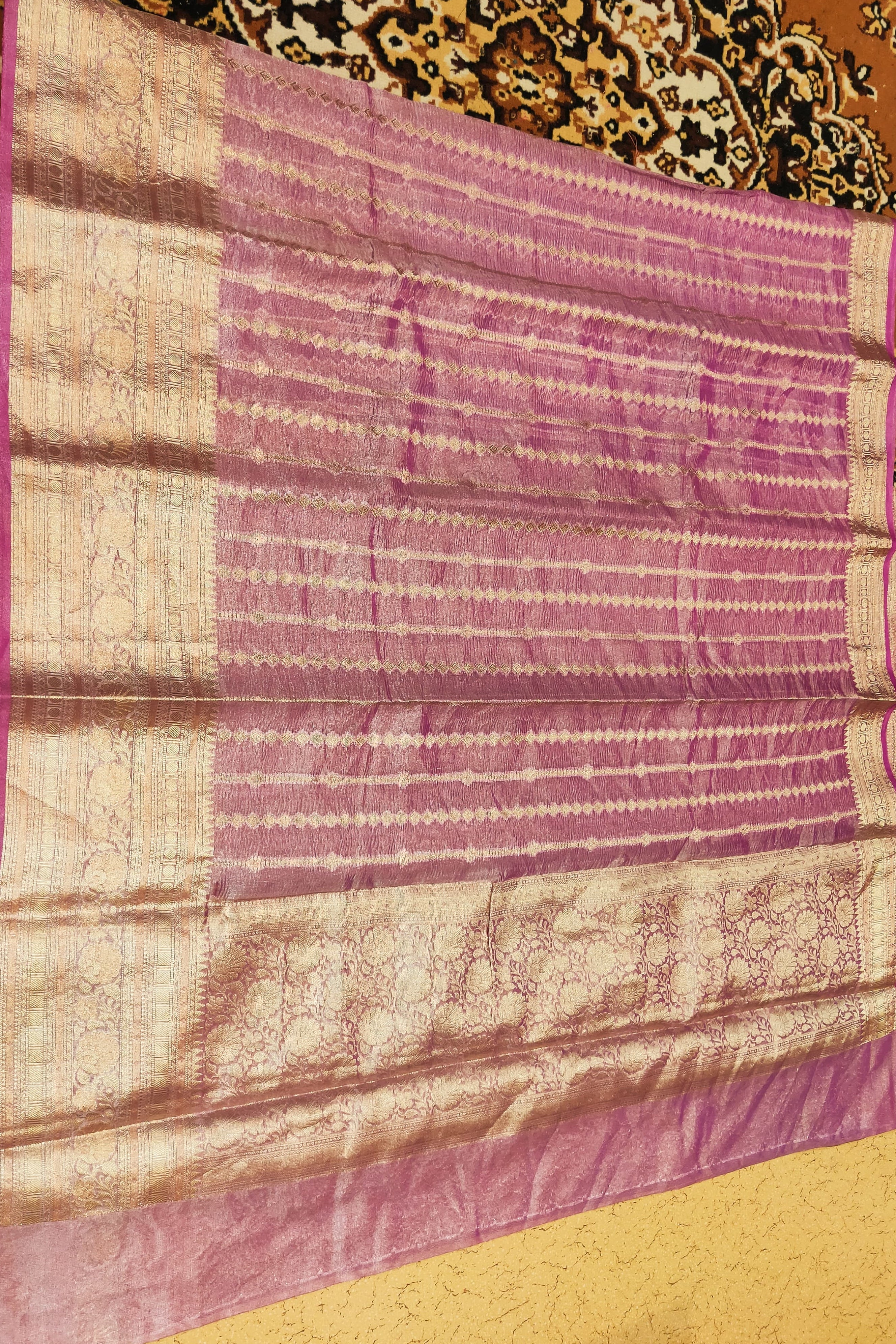 Purple and beige patterned fabric on a decorative background