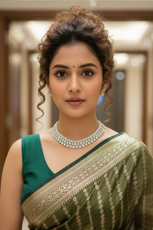 woman in dark green striped saree indoors