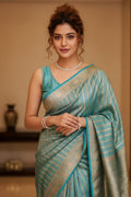 woman in a blue striped saree indoors
