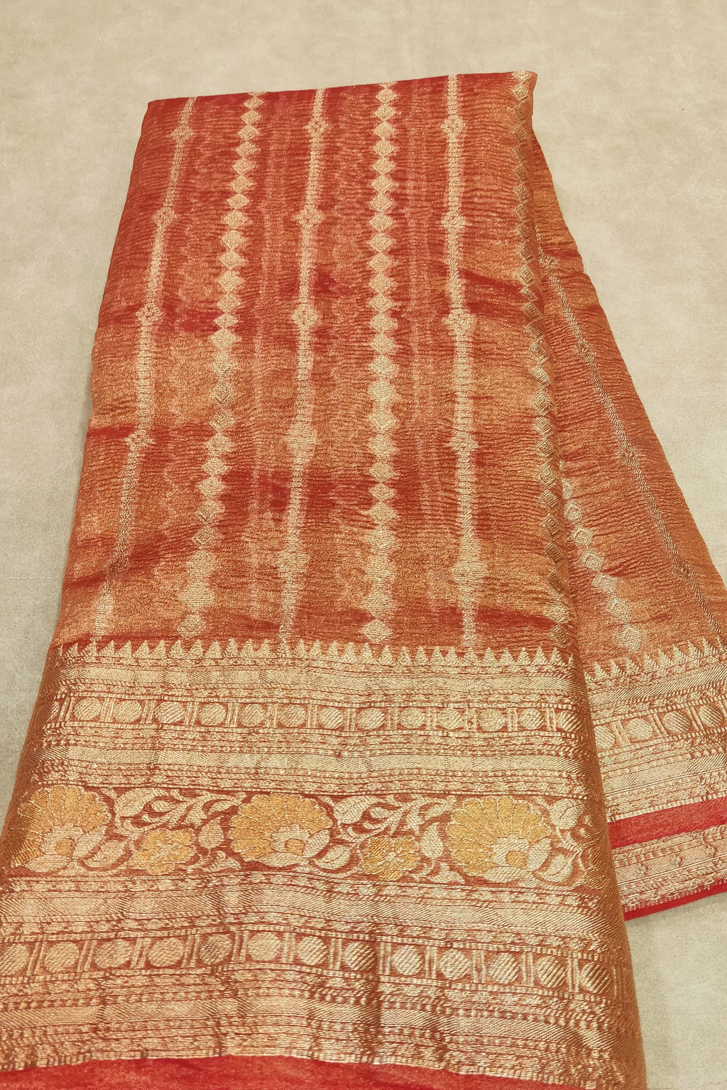 orange saree on a flat surface
