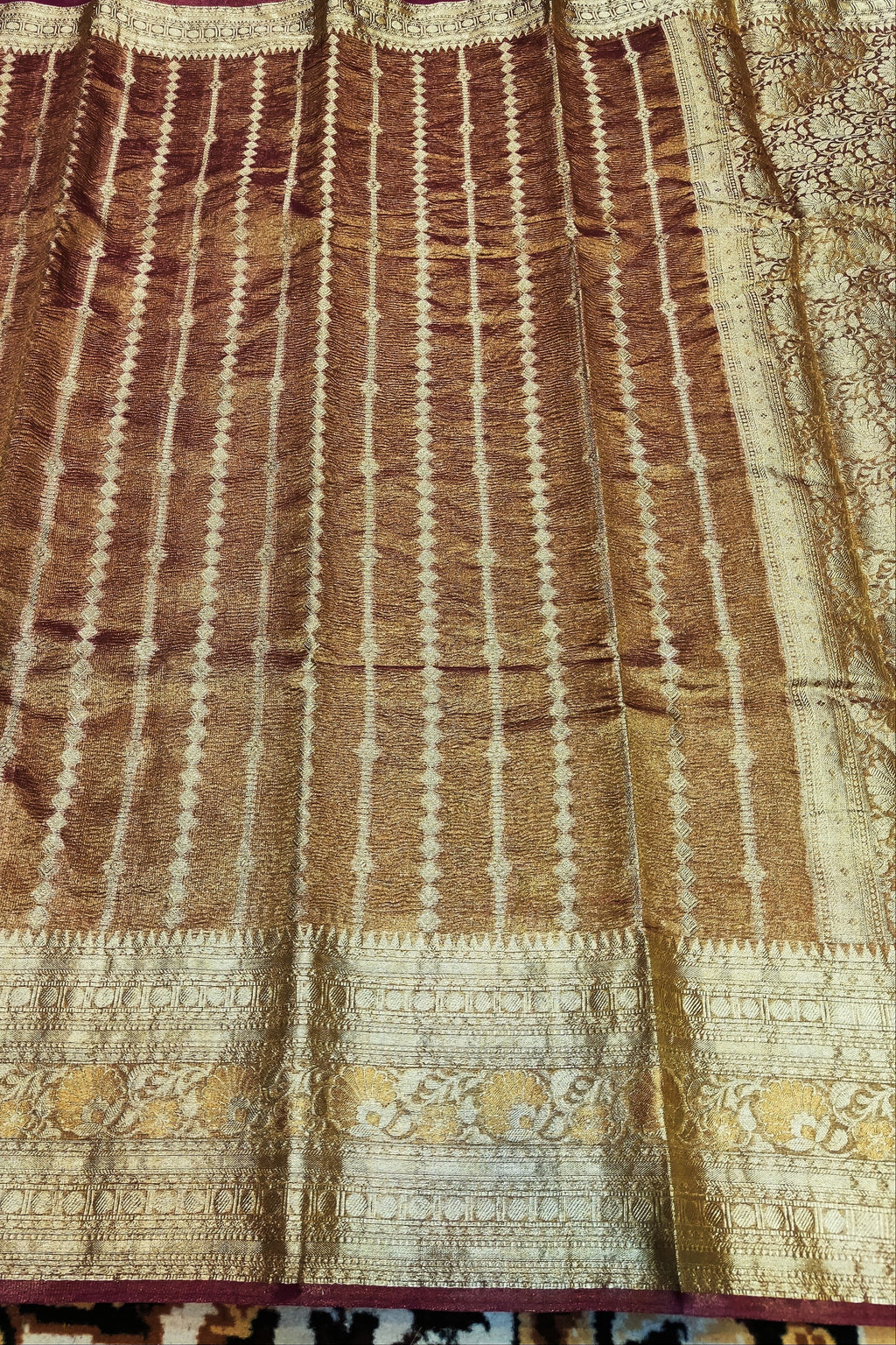 Brown and beige patterned fabric with floral designs