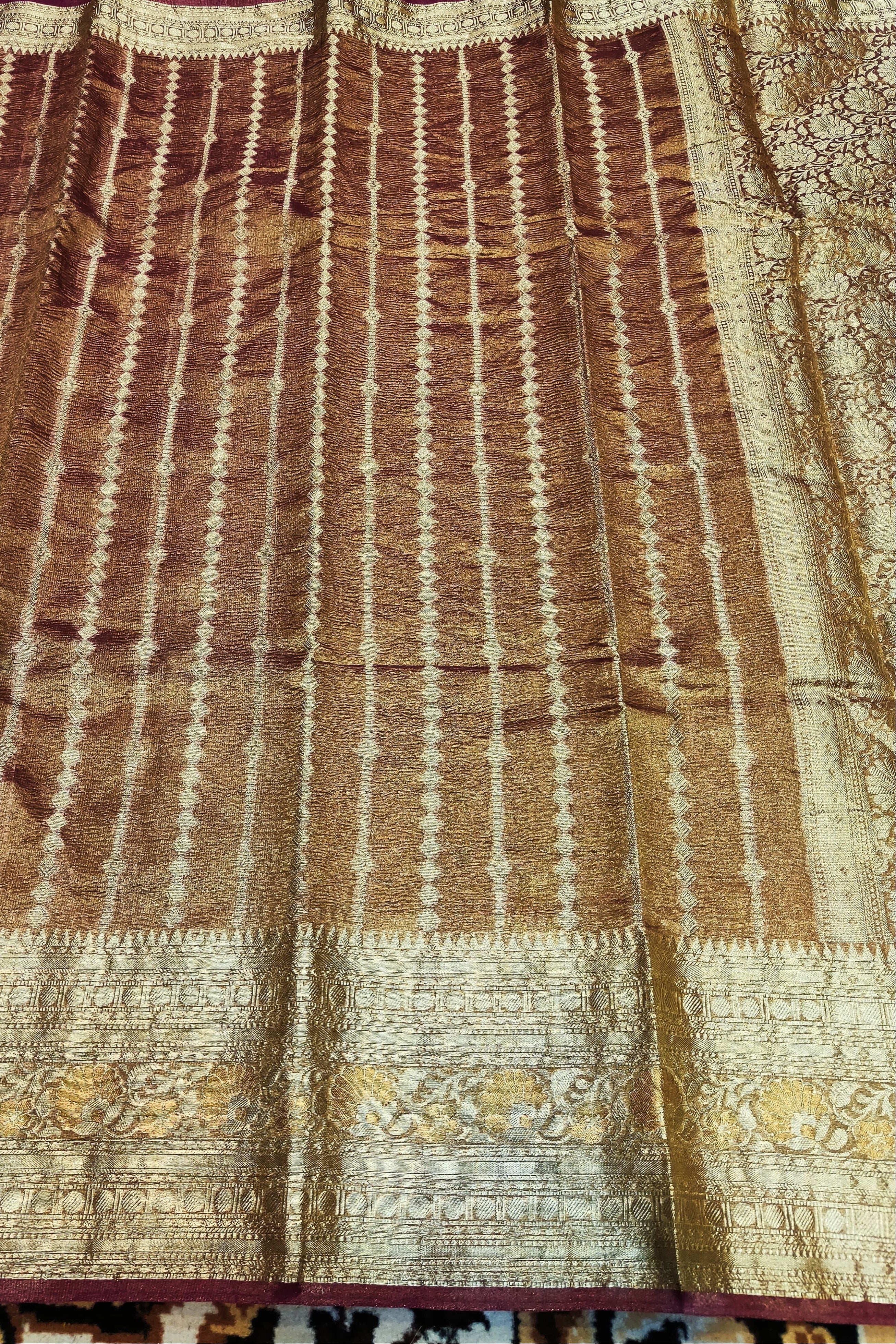 Brown and beige patterned fabric with floral designs