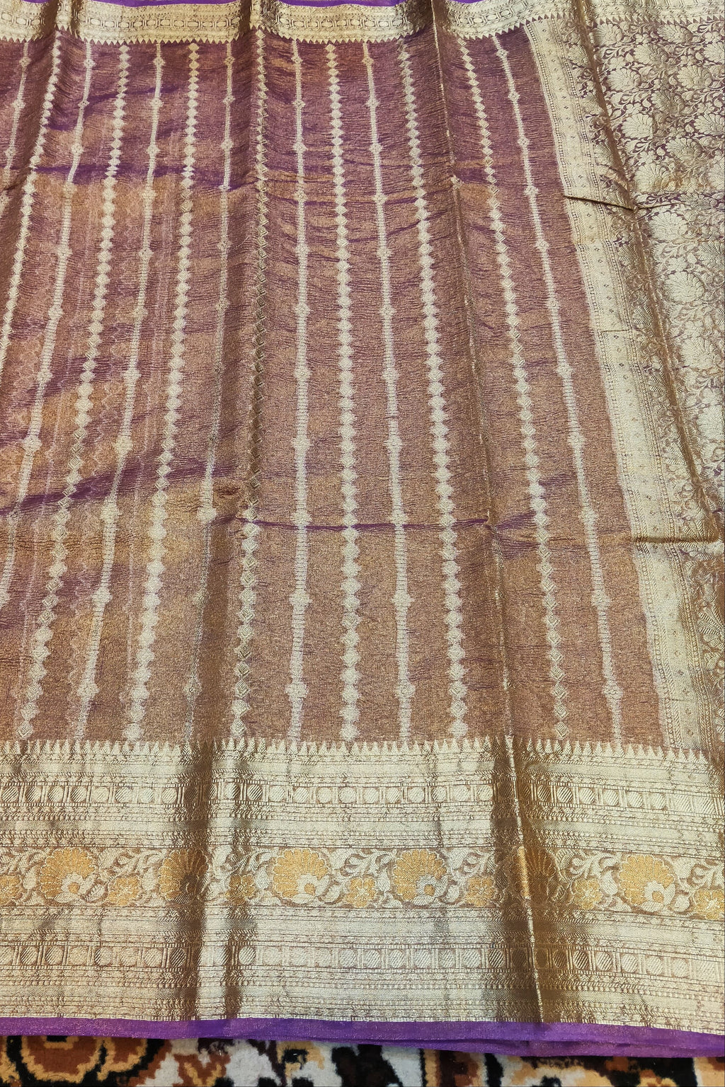 Saree with brown and beige pattern on a fabric background