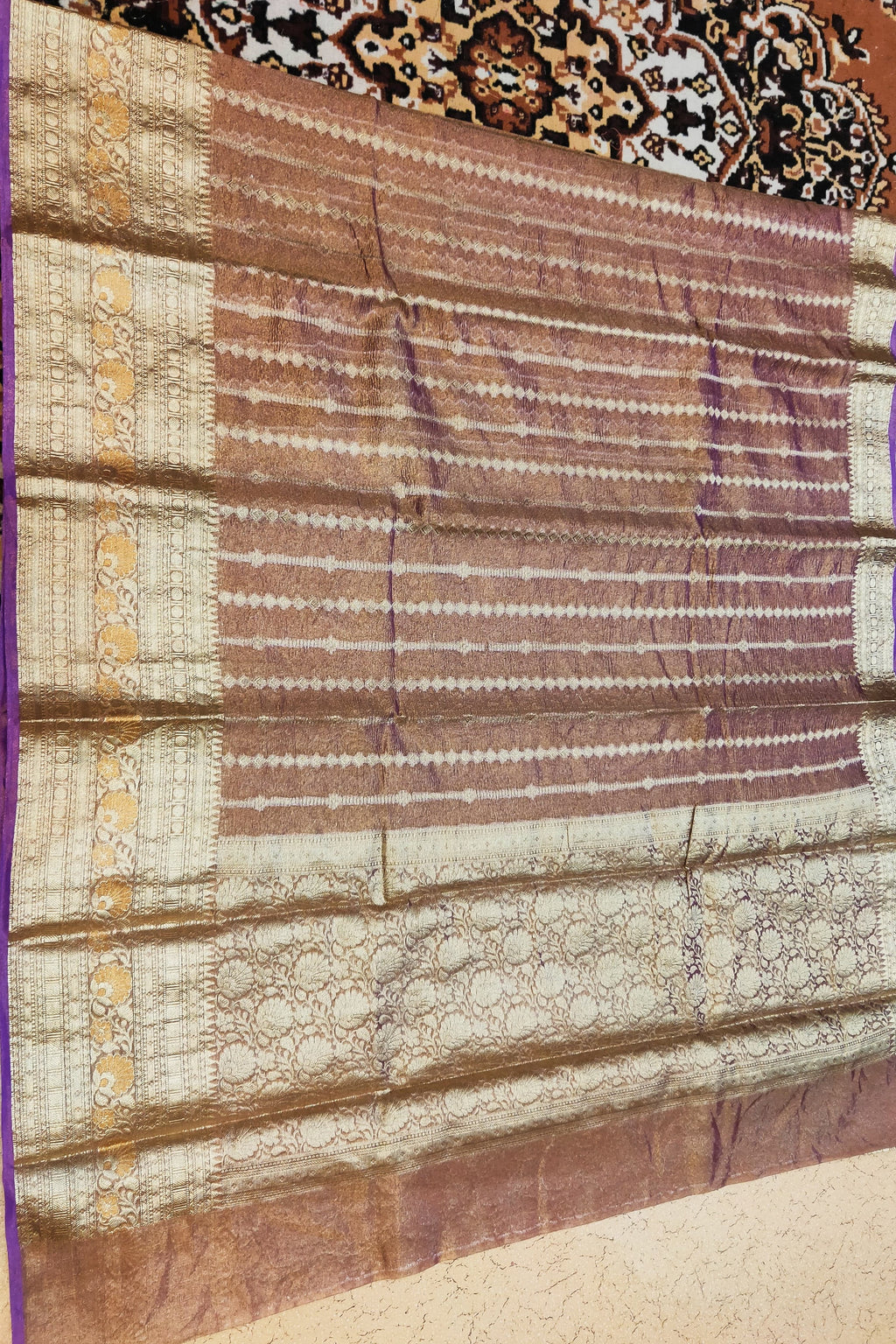 Folded fabric with intricate patterns on a textured surface