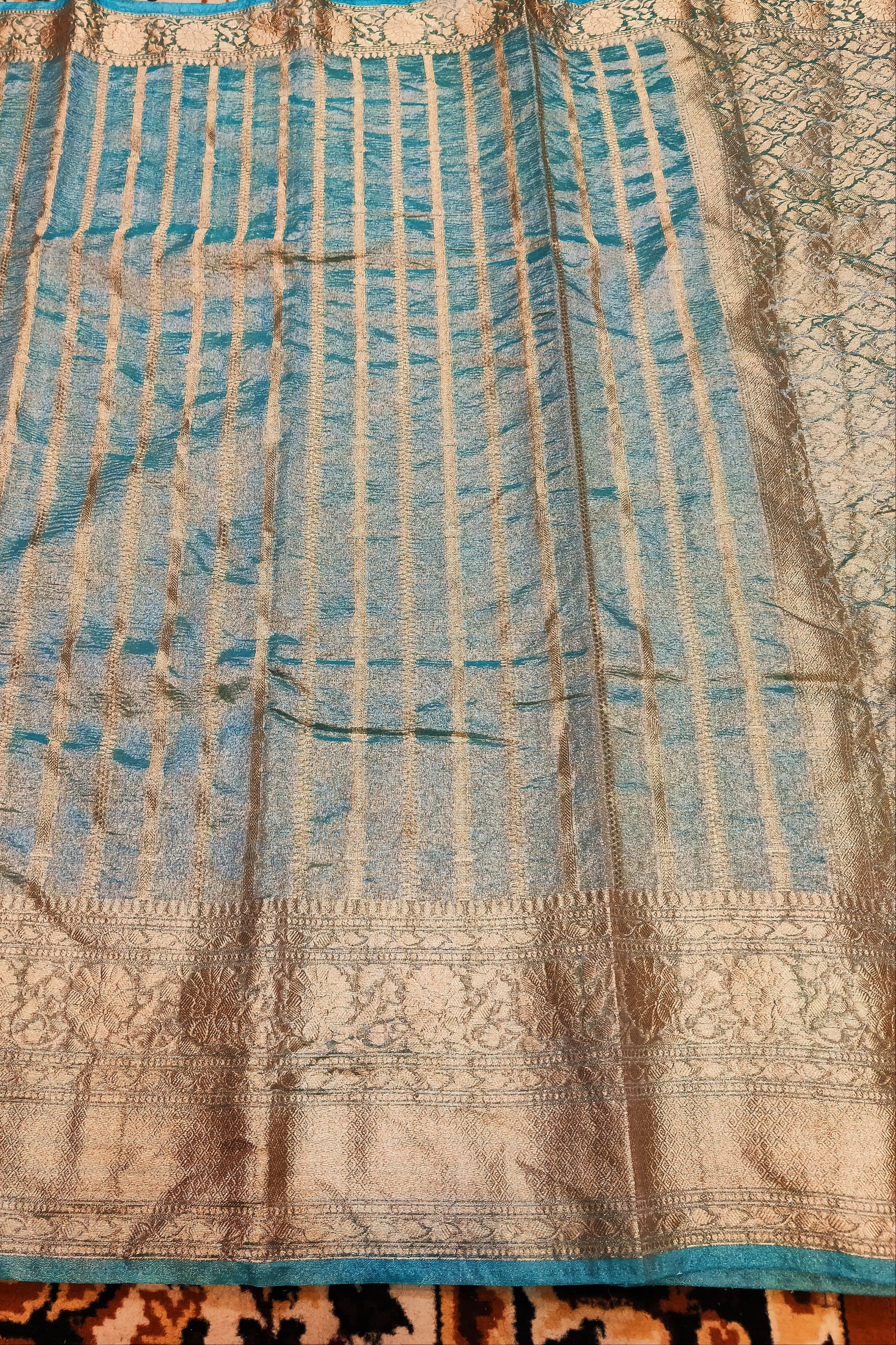 Textured fabric with blue and brown patterns on a patterned surface