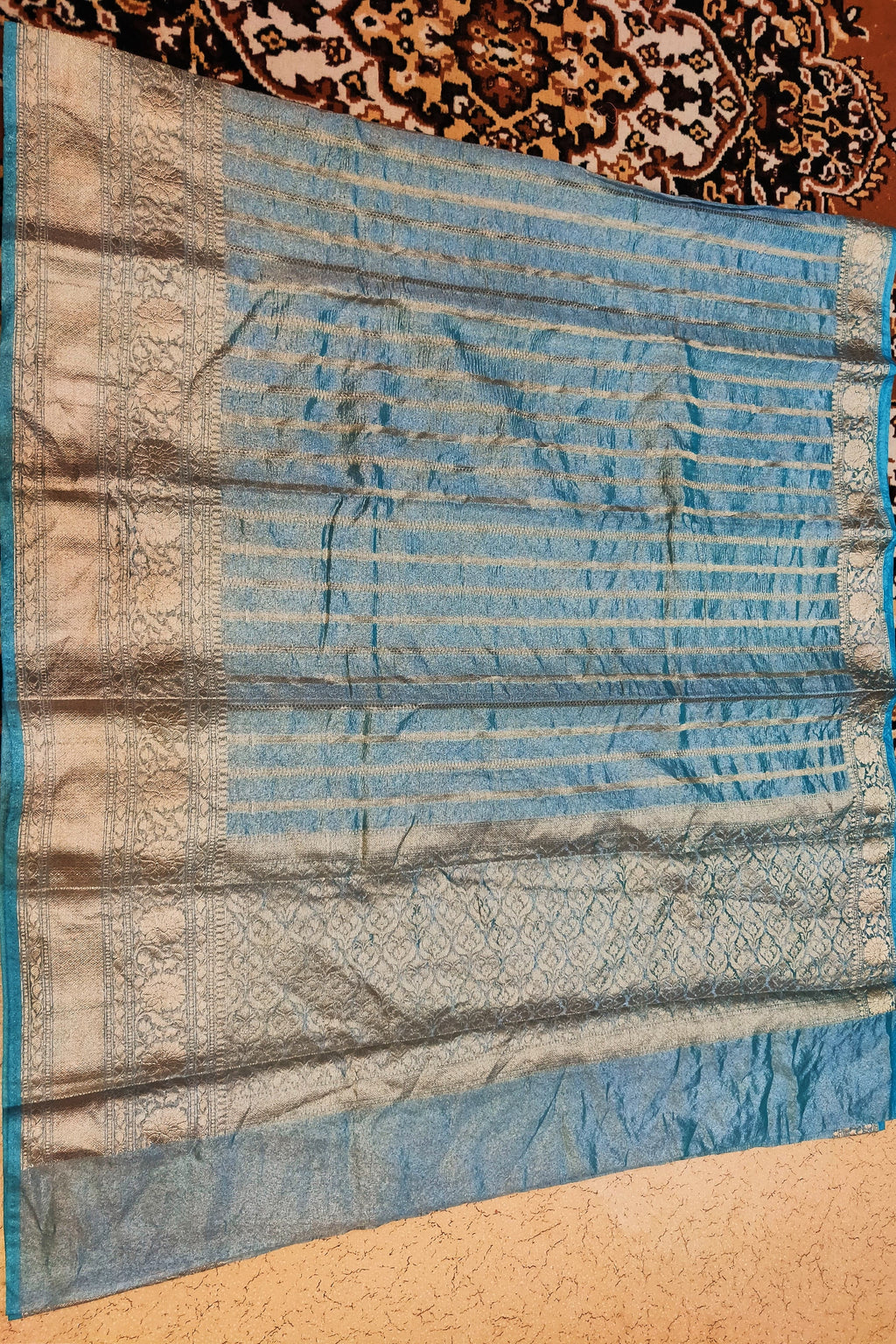 Blue fabric with intricate patterns on a textured surface