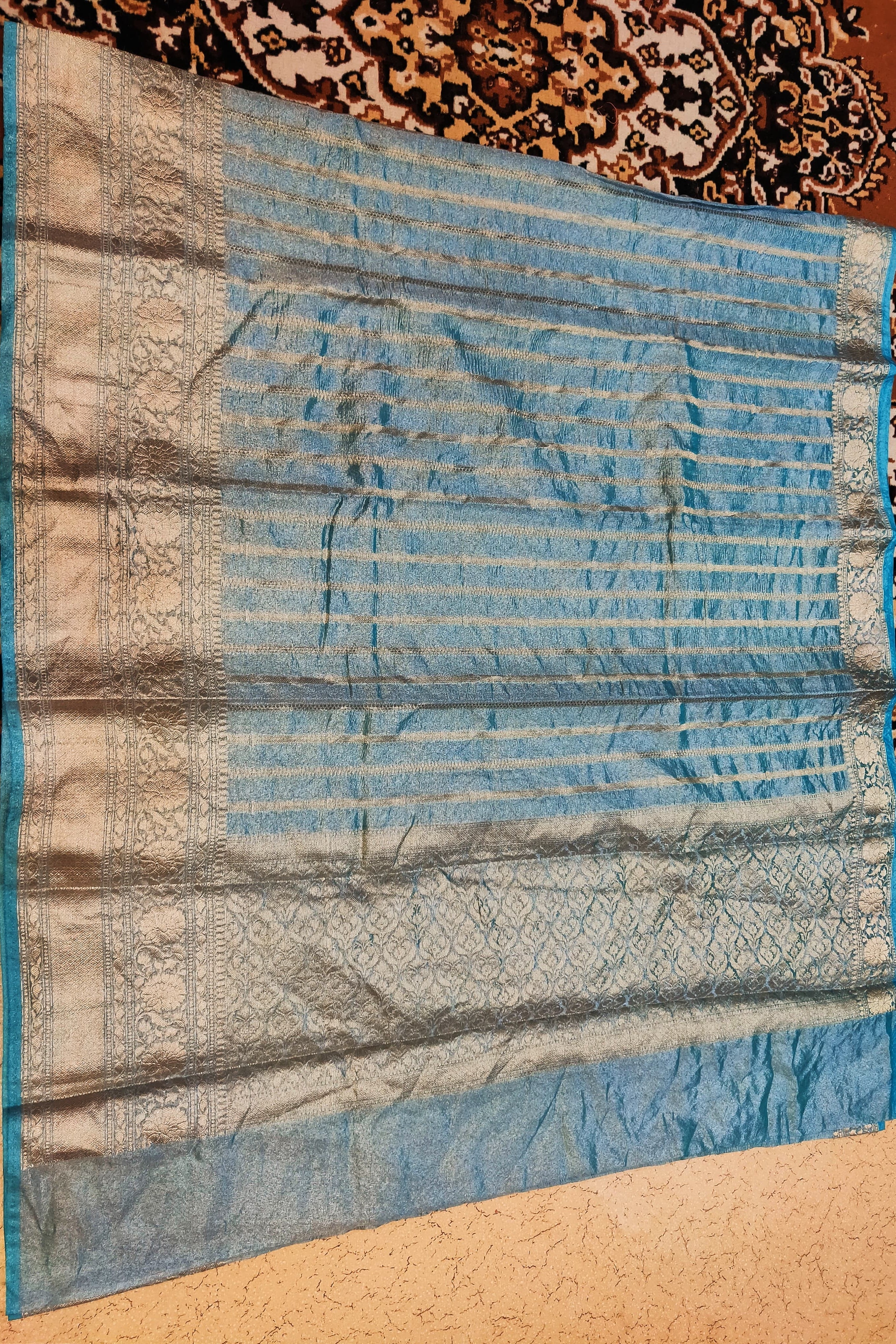 Blue fabric with intricate patterns on a textured surface