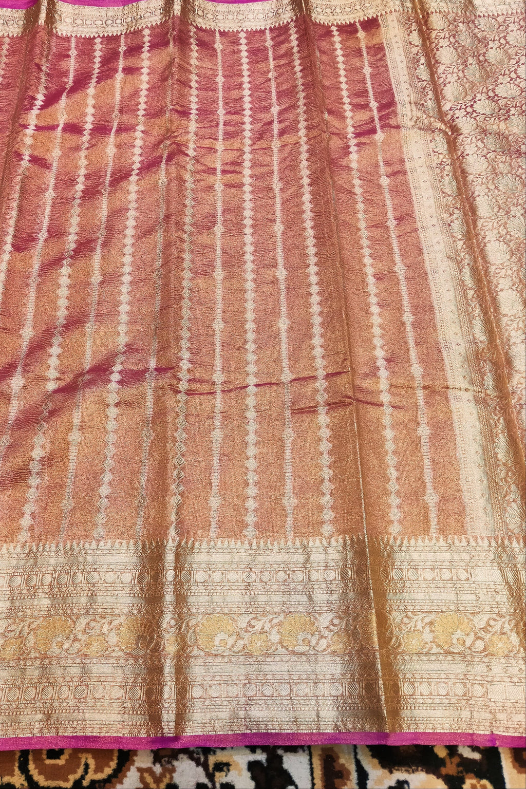 Saree with a patterned border on a textured surface