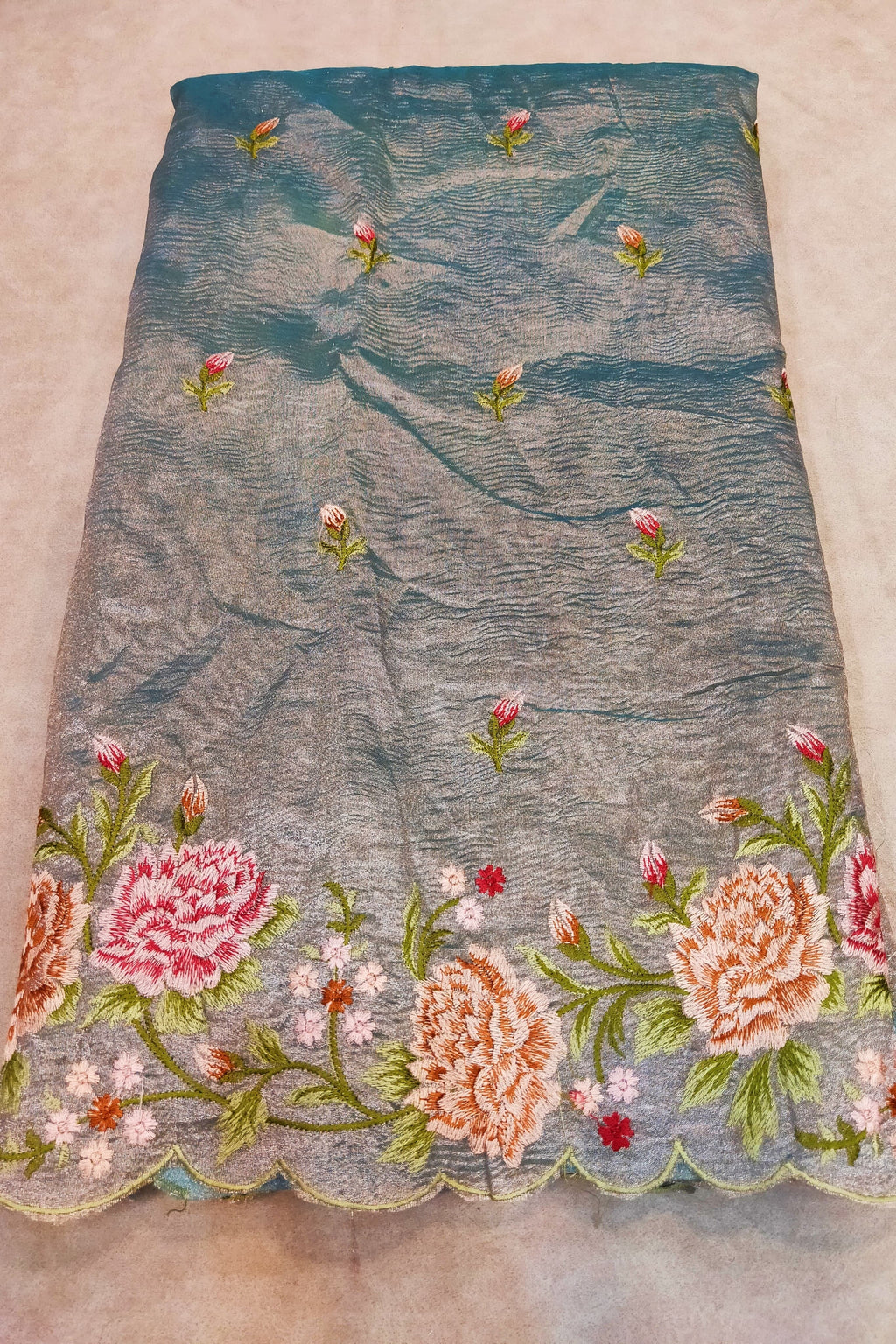 Embroidered fabric with floral patterns on a beige background