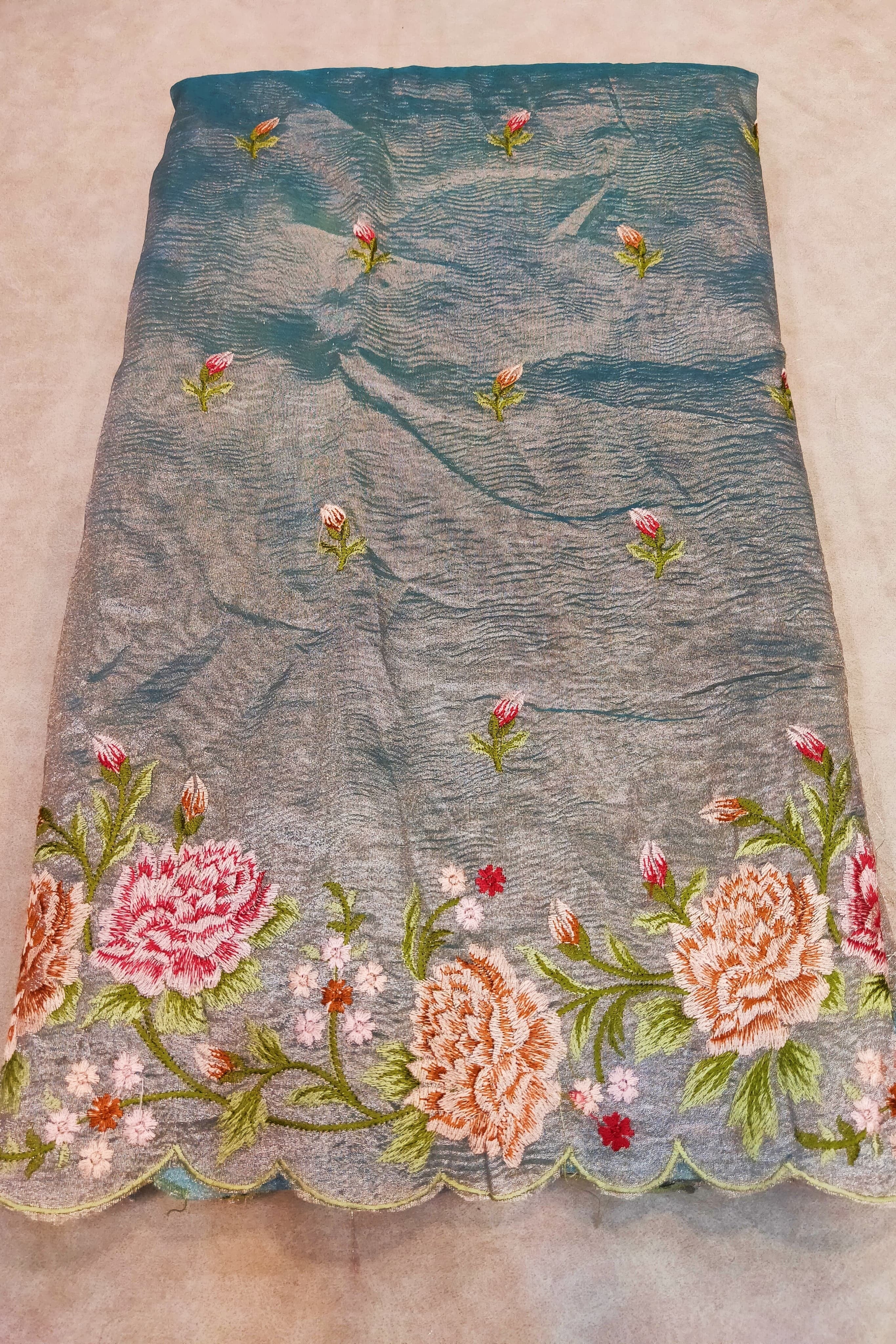 Embroidered fabric with floral patterns on a beige background