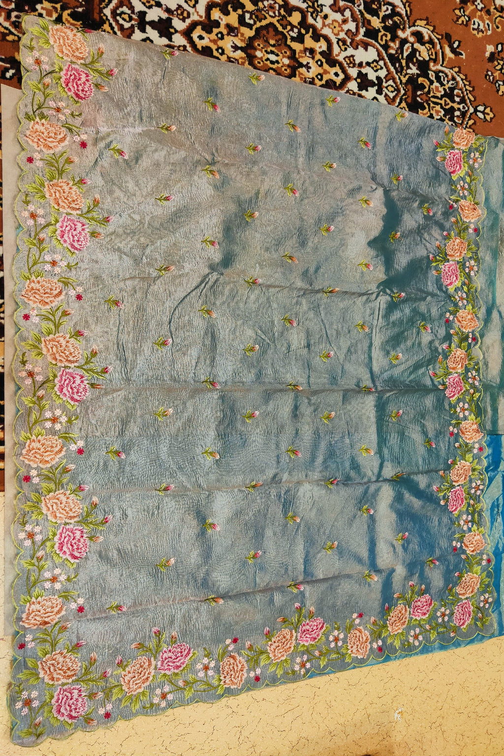 Embroidered fabric with floral patterns on a textured surface