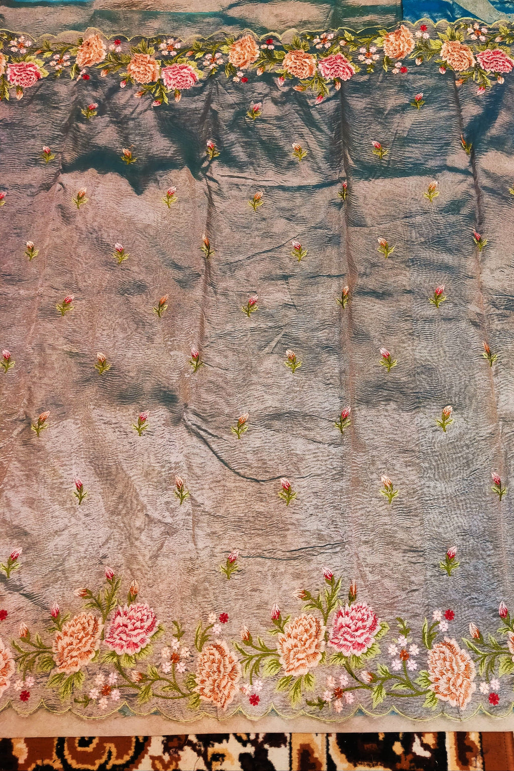 Embroidered fabric with floral patterns on a textured background