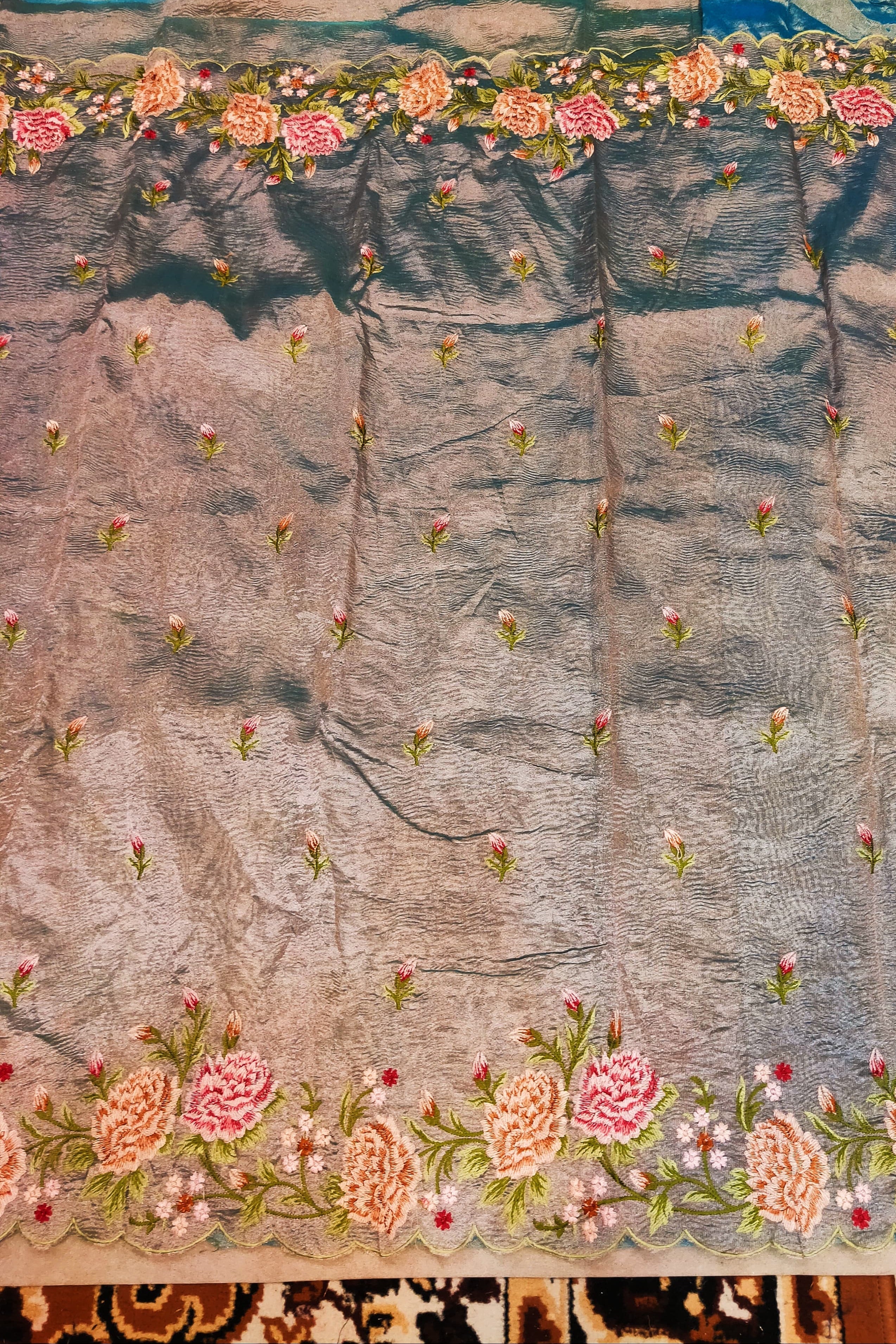 Embroidered fabric with floral patterns on a textured background