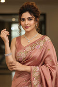 woman wearing a floral saree indoors