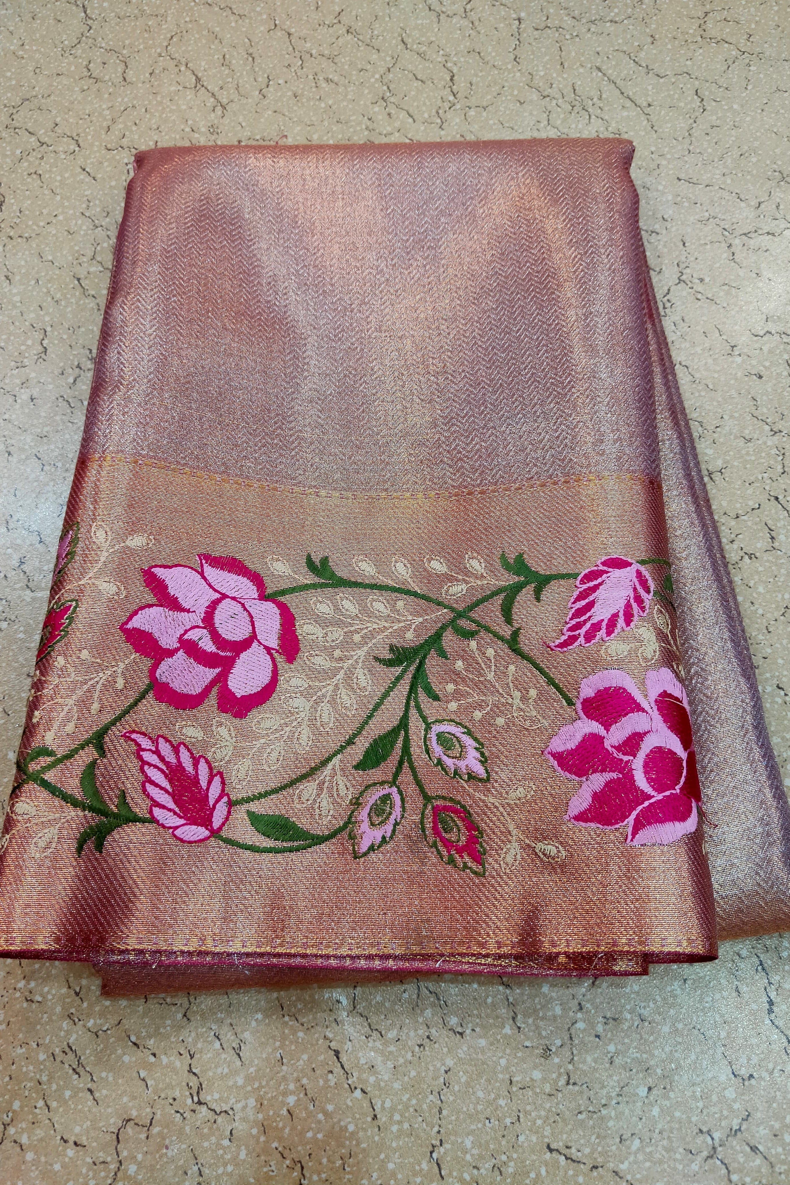 Embroidered fabric with pink flowers on a beige background