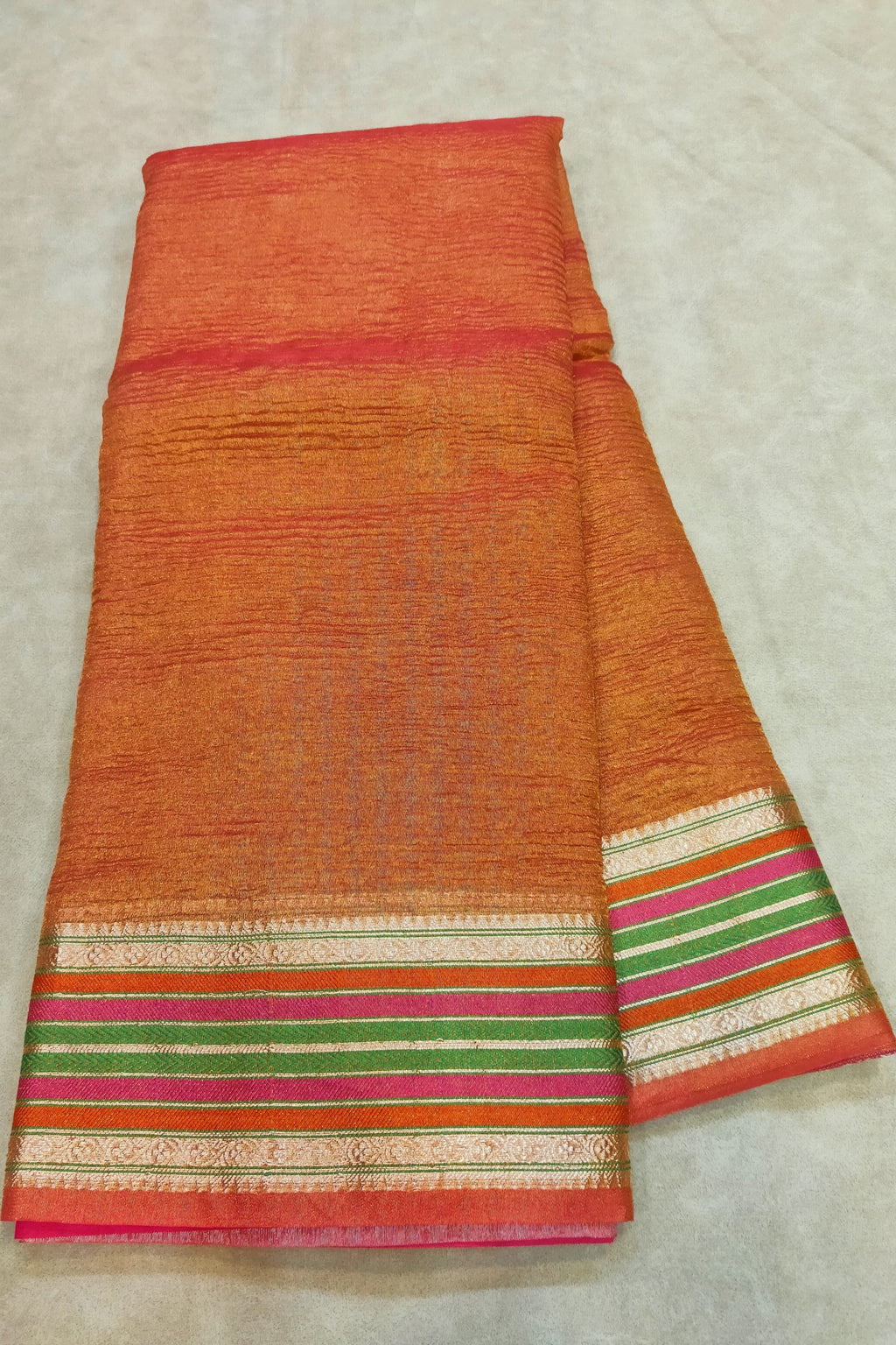 orange saree on a flat surface