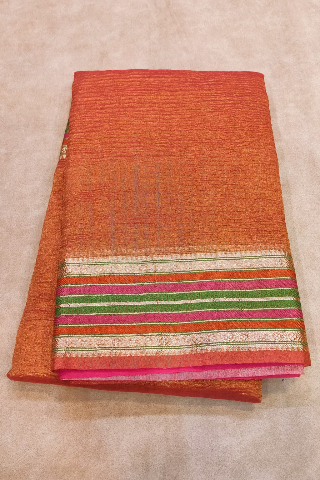 orange saree on a flat surface