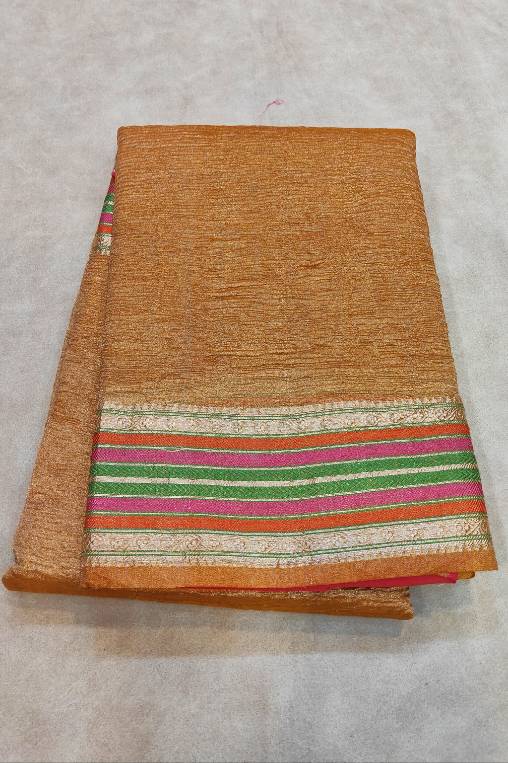 orange saree on a flat surface