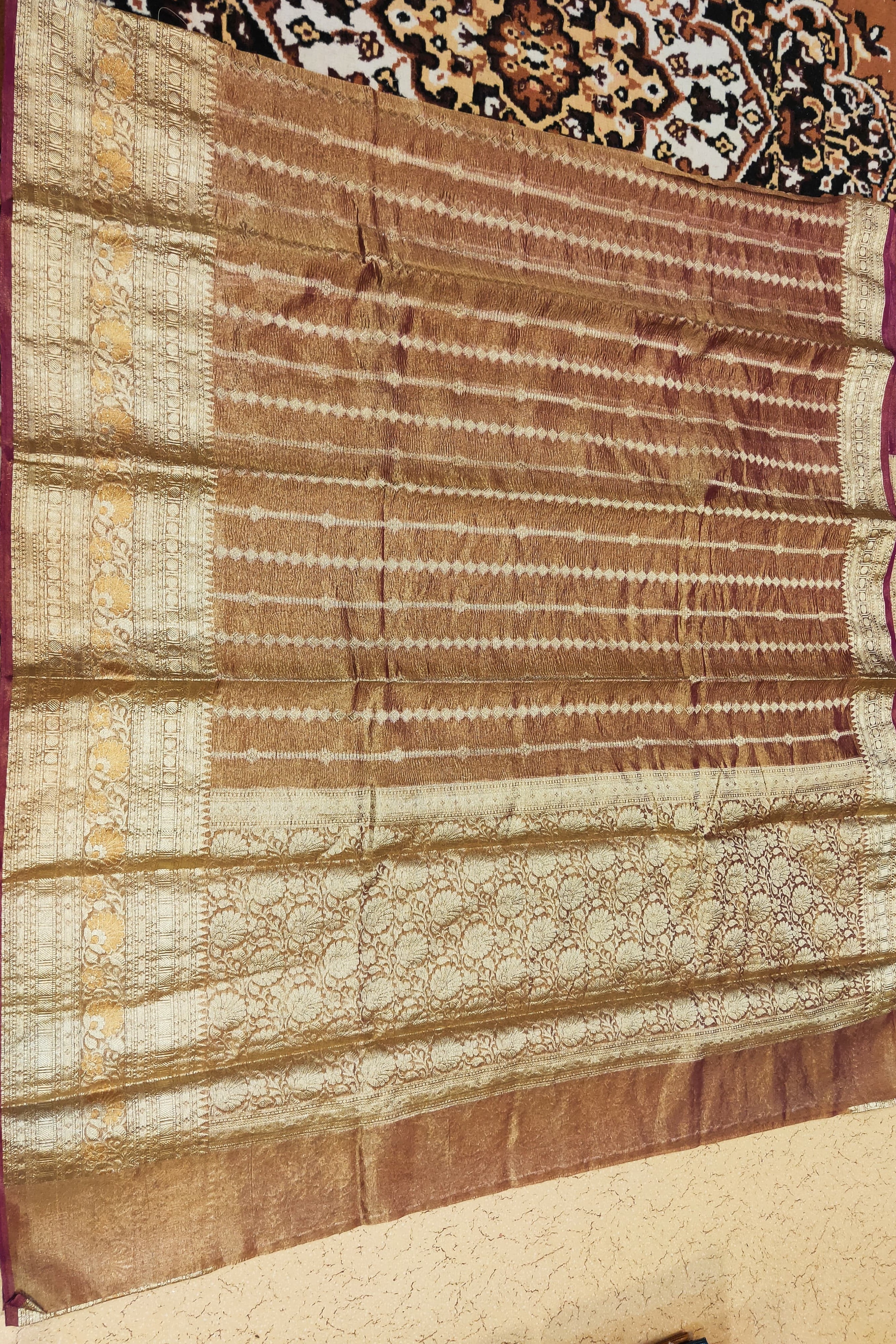 Textile with intricate patterns on a carpeted floor