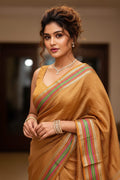 woman wearing orange saree indoors