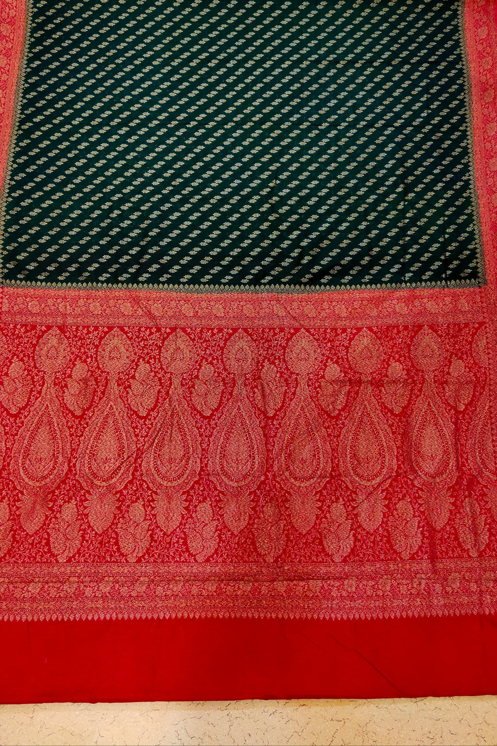 Red and green patterned fabric on a textured surface