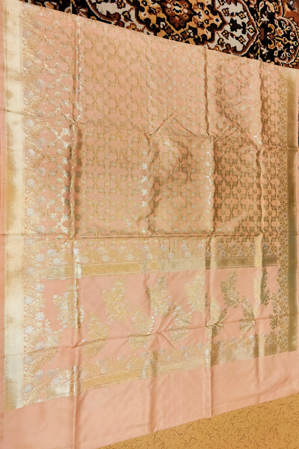 Pink fabric with intricate patterns on a textured surface
