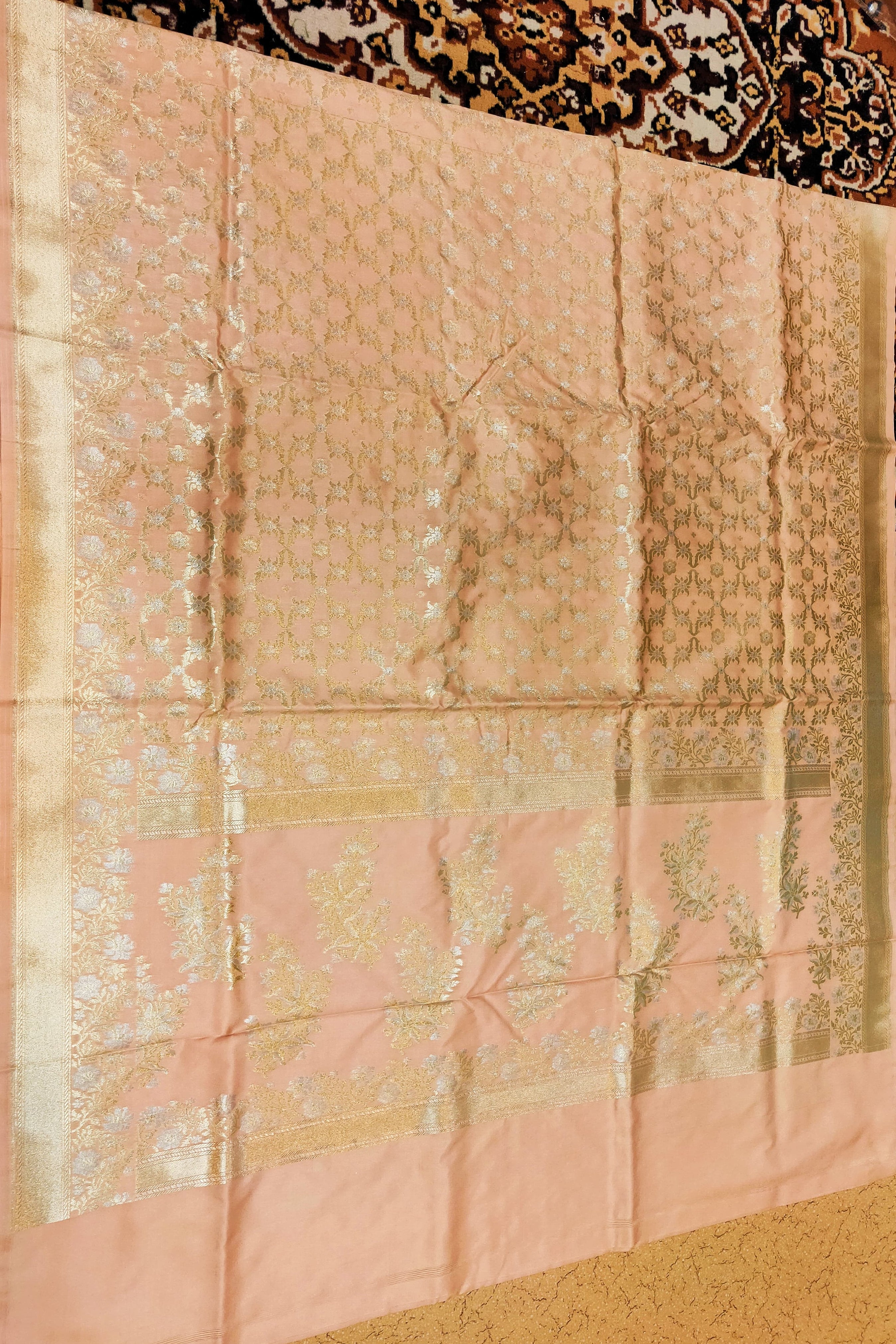 Pink fabric with intricate patterns on a textured surface