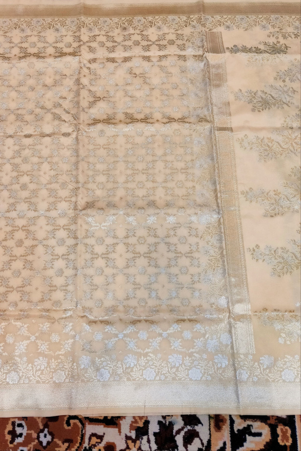 Beige fabric with floral patterns on a patterned rug