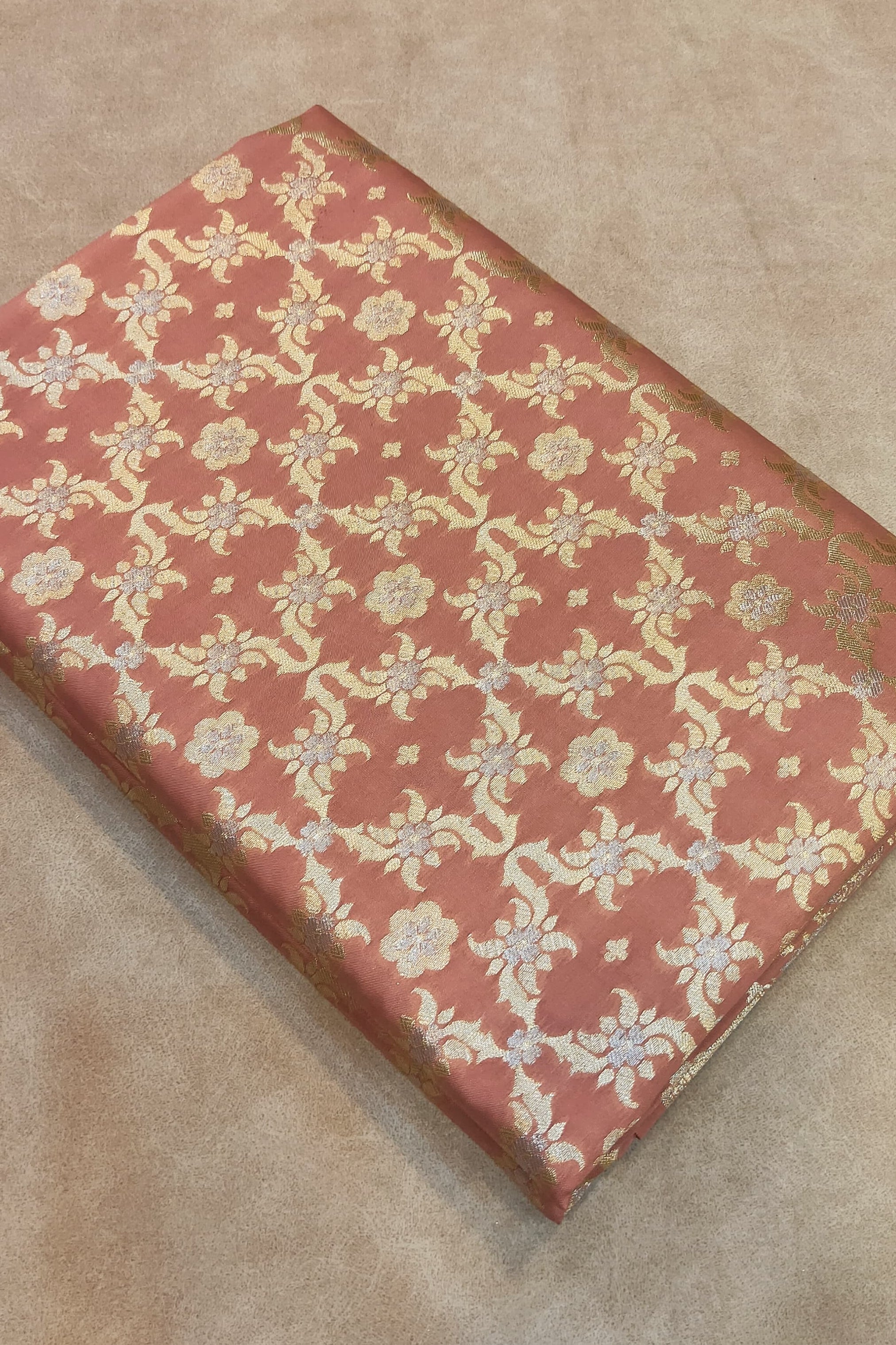 Folded fabric with a floral pattern on a beige surface