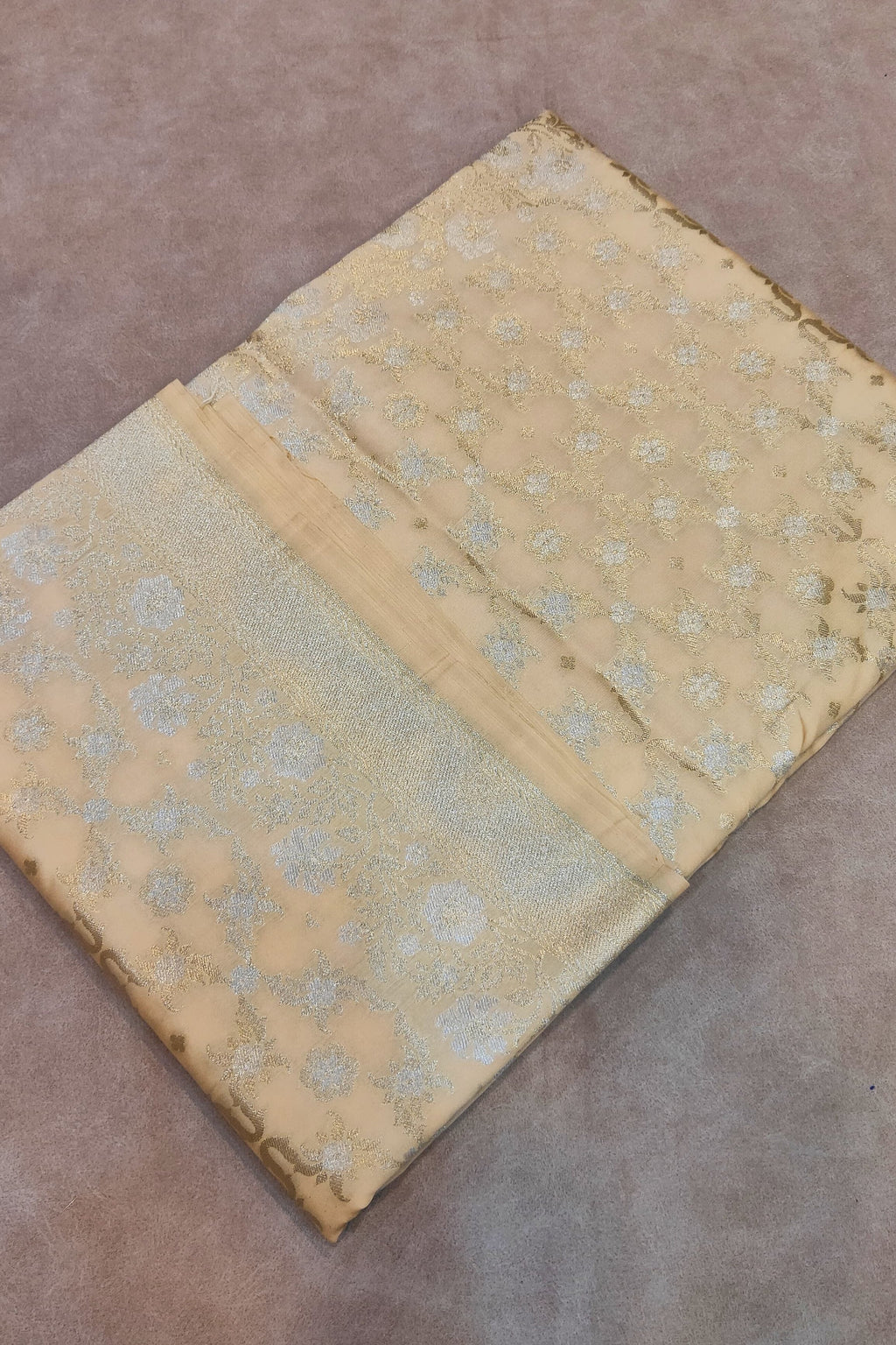 Vintage fabric with floral pattern on a brown surface