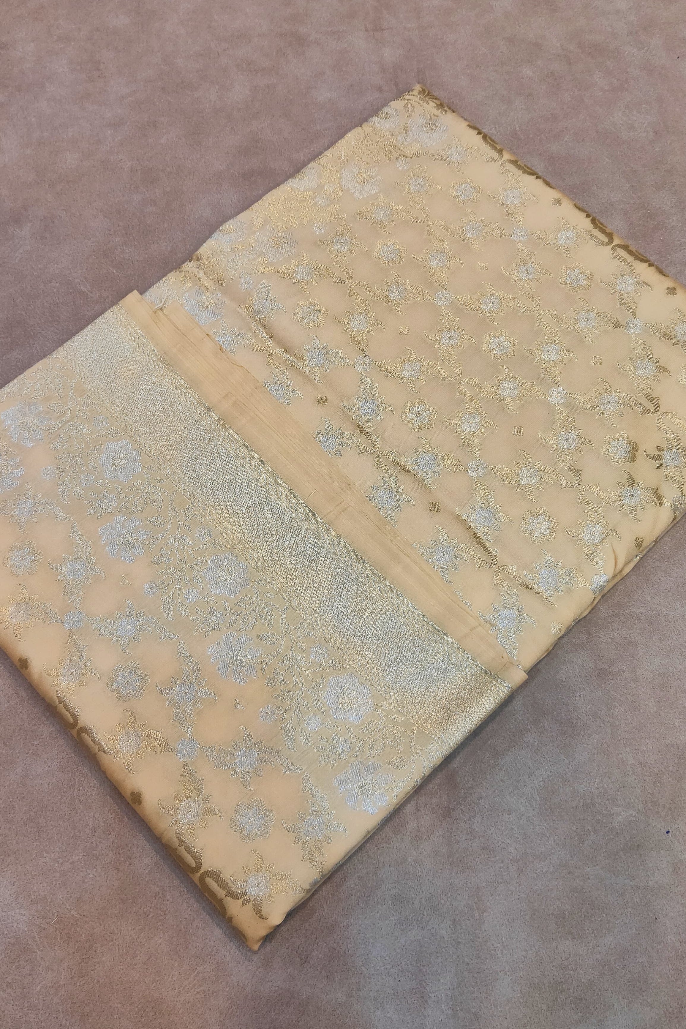 Vintage fabric with floral pattern on a brown surface