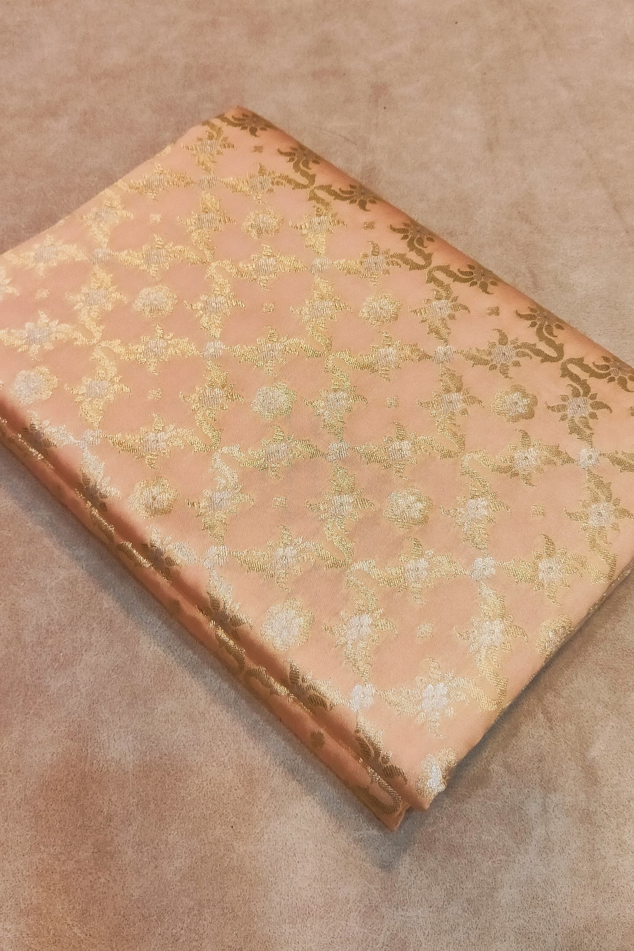Vintage book with floral pattern on a beige surface