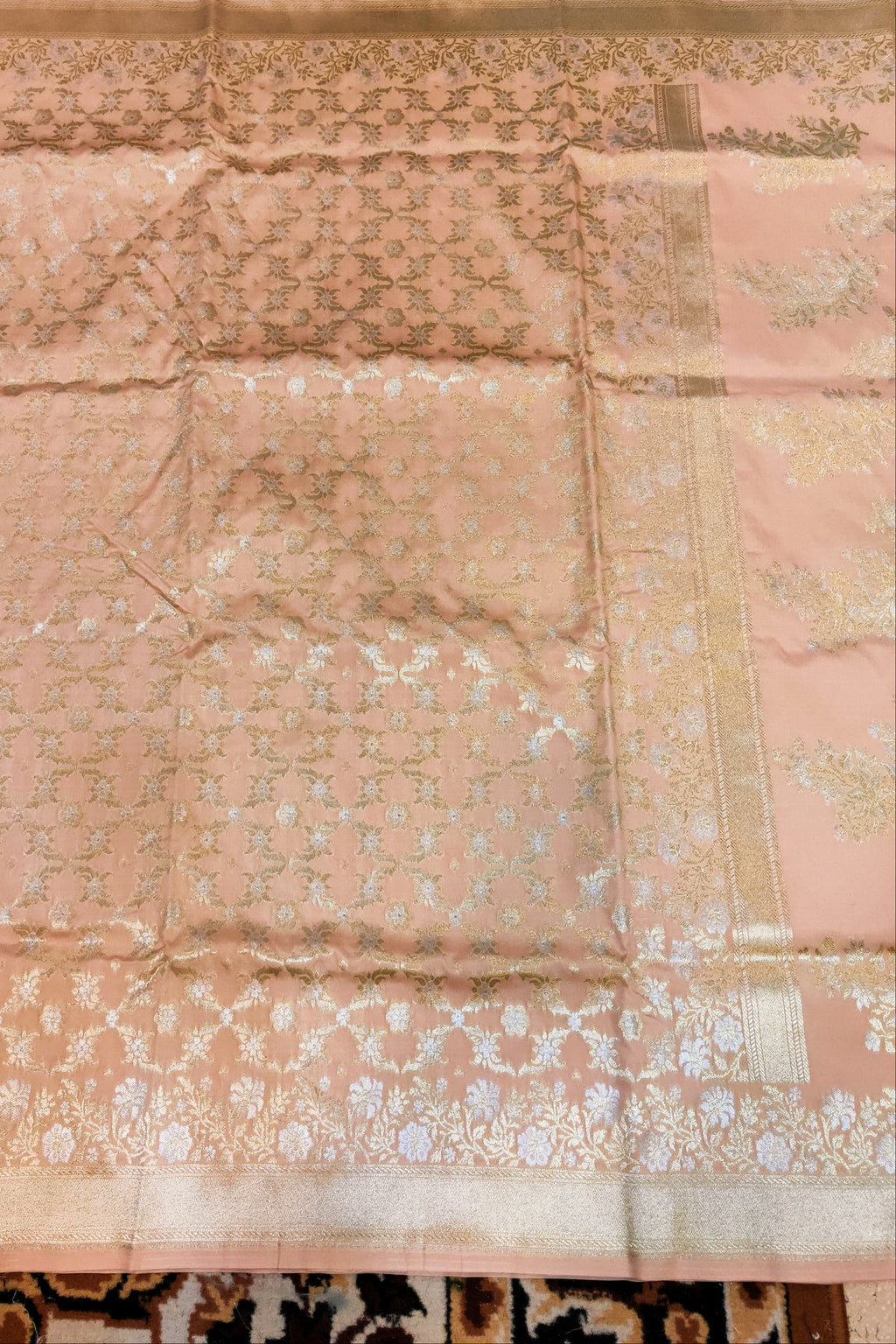 Pink fabric with intricate patterns on a textured surface