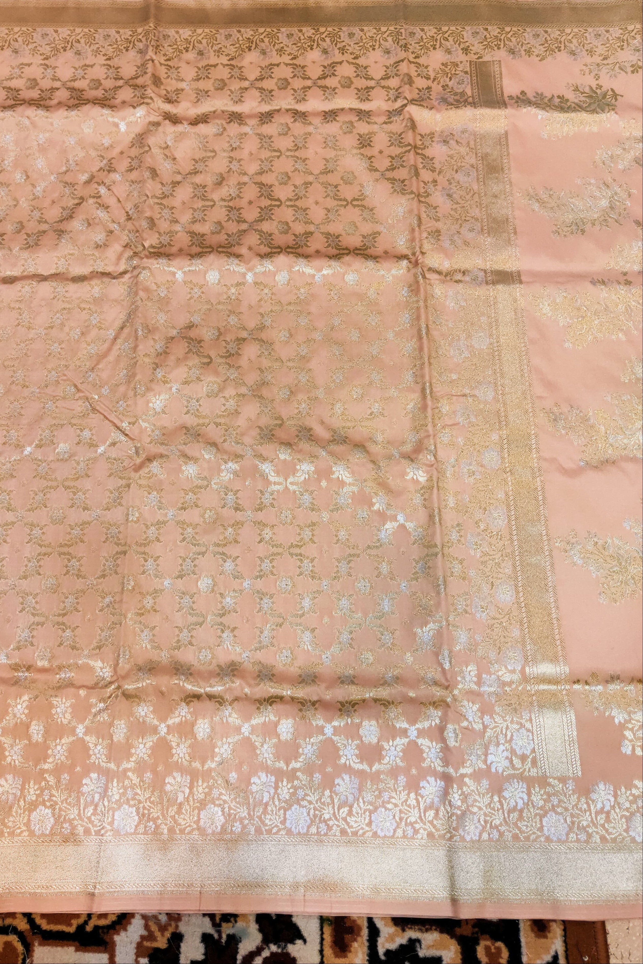 Pink fabric with intricate patterns on a textured surface