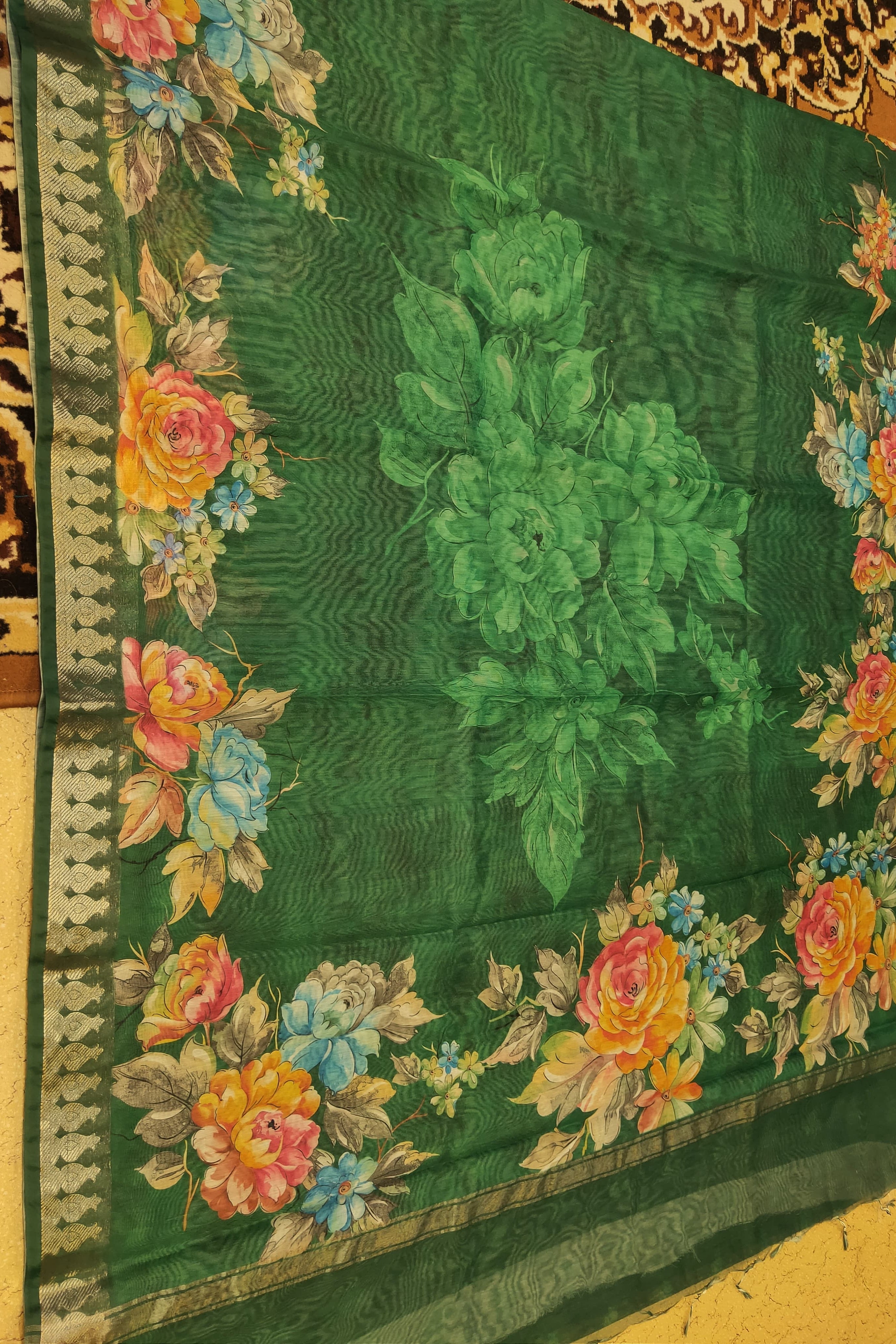 Green fabric with floral embroidery on a yellow background