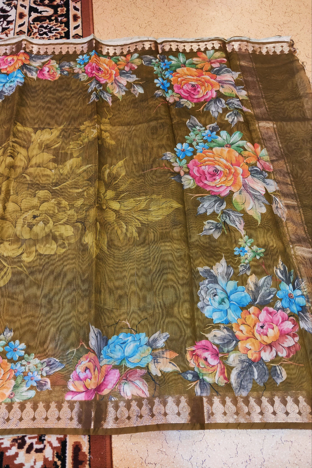 Embroidered fabric with colorful floral patterns on a brown background