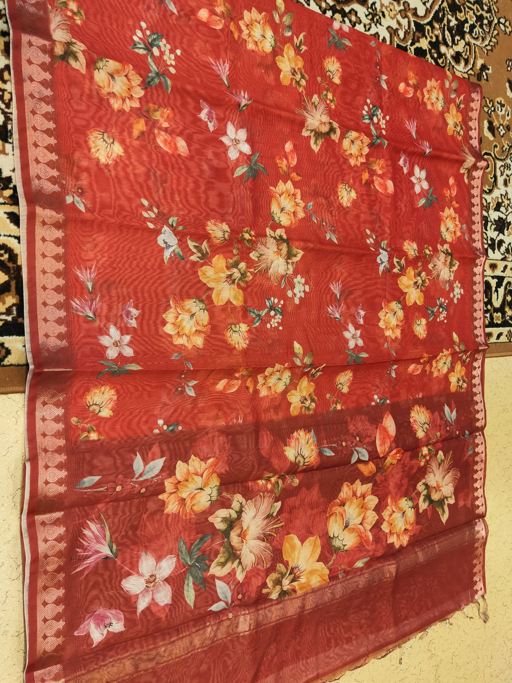 Red floral fabric with a pattern of flowers on a plain background