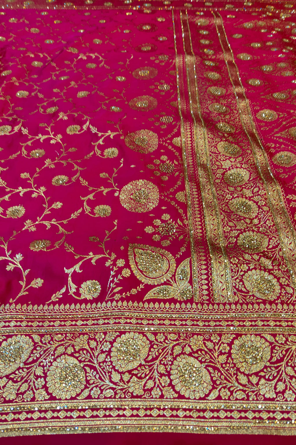 Embroidered fabric with gold patterns on a red background
