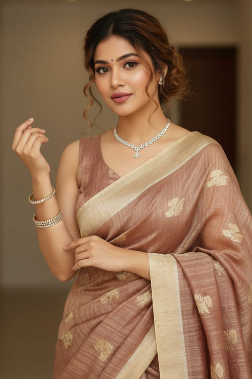 Woman in a traditional saree with a neutral background