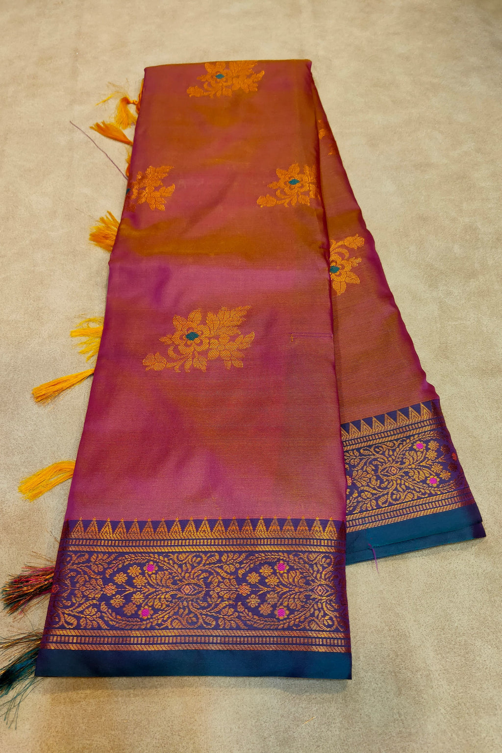 Decorative scarf with intricate patterns and tassels on a beige background